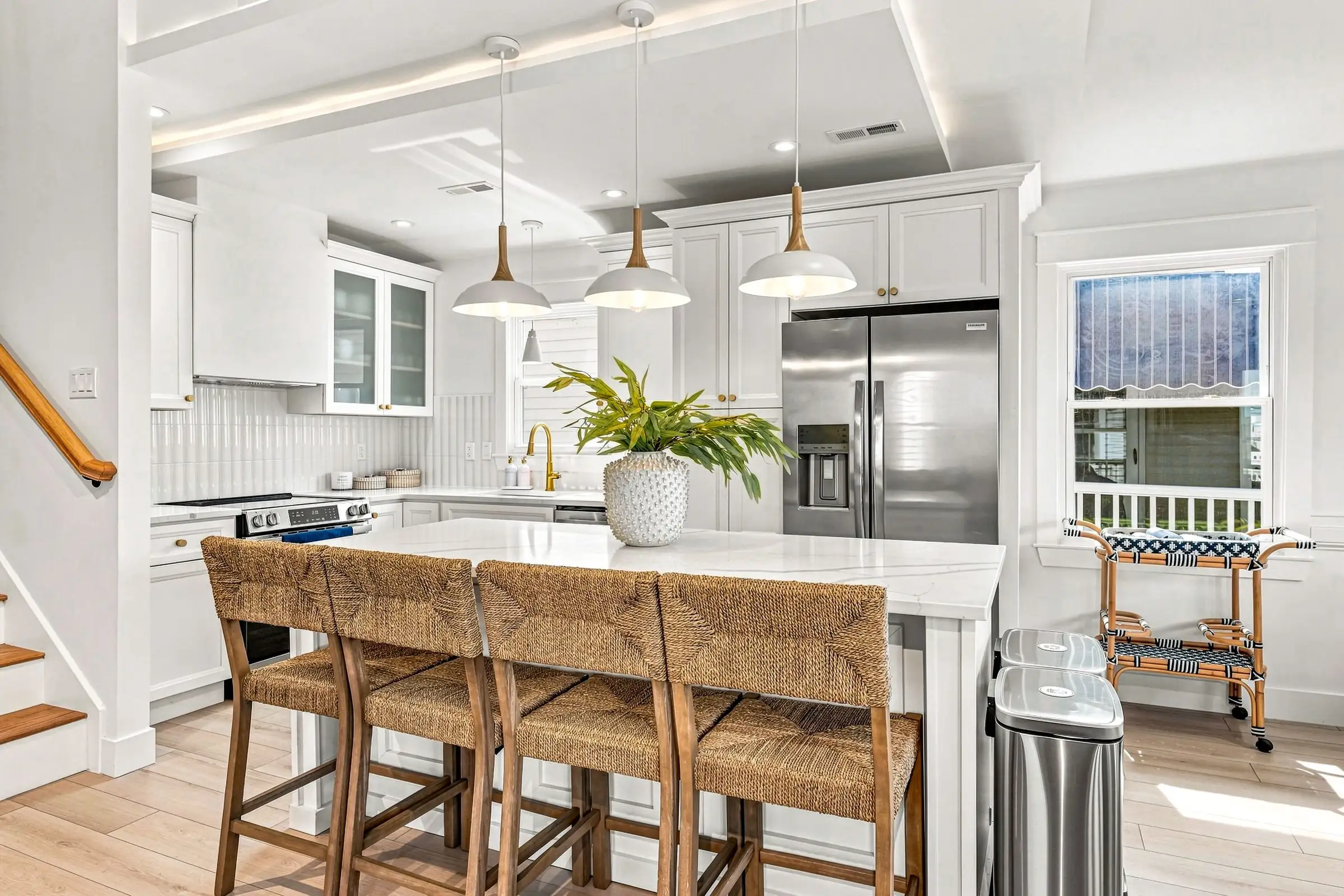 Kitchen island with quartz counter and four woven counter stools